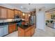 Charming kitchen with an island, stainless steel appliances and wood cabinets at 2387 Nuremberg Blvd, Punta Gorda, FL 33983