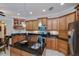 Spacious kitchen featuring wood cabinets, granite countertops and an island with a sink at 2387 Nuremberg Blvd, Punta Gorda, FL 33983