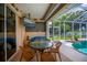 Lanai featuring outdoor dining, TV, and views of the pool and yard at 2387 Nuremberg Blvd, Punta Gorda, FL 33983