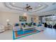 Spacious living room featuring a stylish sofa, bright accent rug, and sliding glass doors leading to the outdoors at 2387 Nuremberg Blvd, Punta Gorda, FL 33983