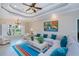 Bright living room with large windows, a comfortable sofa, and a view of the landscaped surroundings at 2387 Nuremberg Blvd, Punta Gorda, FL 33983