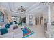 Expansive living room with elegant tray ceilings, neutral decor, and seamless transition to the outdoor living space at 2387 Nuremberg Blvd, Punta Gorda, FL 33983