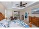 Bright main bedroom boasts a ceiling fan, private backyard access, and beach-themed decor at 2387 Nuremberg Blvd, Punta Gorda, FL 33983