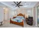 Comfortable main bedroom with a large bed, ceiling fan, and windows with plantation shutters at 2387 Nuremberg Blvd, Punta Gorda, FL 33983