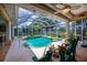Inviting screened-in pool area featuring a sparkling pool and outdoor seating, perfect for relaxation at 2387 Nuremberg Blvd, Punta Gorda, FL 33983