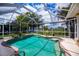 Screened-in pool and spa with an in-water table and landscaping at 2387 Nuremberg Blvd, Punta Gorda, FL 33983