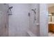 Bathroom shower with updated tile, dual shower heads and built in soap and shampoo niche at 2387 Nuremberg Blvd, Punta Gorda, FL 33983