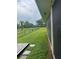 A spacious grassy backyard with a black chain-link fence and mature trees offers privacy and space at 26129 Madras Ct, Punta Gorda, FL 33983