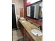Elegant bathroom featuring double sinks with granite countertops and modern fixtures at 26129 Madras Ct, Punta Gorda, FL 33983
