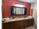 This bathroom boasts double sinks, granite counters, and dark wood cabinets at 26129 Madras Ct, Punta Gorda, FL 33983