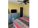 Bedroom featuring a dresser and TV, complemented by bright yellow walls at 26129 Madras Ct, Punta Gorda, FL 33983