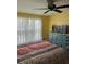 Bedroom showcasing a dresser, TV and natural light coming in from a large window at 26129 Madras Ct, Punta Gorda, FL 33983