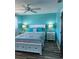 Bedroom with blue walls, white trim, bed, ceiling fan, and natural light at 26129 Madras Ct, Punta Gorda, FL 33983