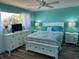 This bedroom features a white bed and dressers with a view to the exterior at 26129 Madras Ct, Punta Gorda, FL 33983