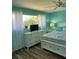 Bedroom with blue walls, white trim, bed, ceiling fan, and natural light at 26129 Madras Ct, Punta Gorda, FL 33983