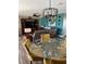 Stylish dining area featuring a glass table with yellow chairs and a modern chandelier at 26129 Madras Ct, Punta Gorda, FL 33983