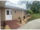 Inviting home featuring a brick walkway, lush landscaping, and a classic double door entry at 26129 Madras Ct, Punta Gorda, FL 33983