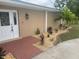 Inviting home featuring a brick walkway, lush landscaping, and a classic double door entry at 26129 Madras Ct, Punta Gorda, FL 33983