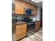 A well-equipped kitchen featuring stainless steel appliances and wooden cabinets for ample storage space at 26129 Madras Ct, Punta Gorda, FL 33983