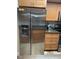 Modern kitchen featuring stainless steel appliances, wood cabinetry, and sleek countertops at 26129 Madras Ct, Punta Gorda, FL 33983