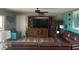 A cozy living room with modern decor, wooden flooring, and large entertainment center at 26129 Madras Ct, Punta Gorda, FL 33983