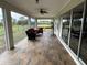 Spacious screened-in patio with comfortable seating and scenic backyard views at 26129 Madras Ct, Punta Gorda, FL 33983