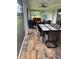 View of the outdoor patio with a dining table, tile floors, and an outdoor grill at 26129 Madras Ct, Punta Gorda, FL 33983