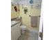 Fun bathroom featuring decor of marine animals, sink, toilet, and towel rack at 311 Garvin St # 405B, Punta Gorda, FL 33950