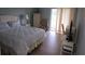 Cozy bedroom with waterfront view, ceiling fan, and access to the screened porch at 311 Garvin St # 405B, Punta Gorda, FL 33950