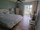 Cozy bedroom with waterfront view, ceiling fan, and access to the screened porch at 311 Garvin St # 405B, Punta Gorda, FL 33950