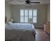 Bedroom featuring light walls, wood floors, a ceiling fan and a large window at 311 Garvin St # 405B, Punta Gorda, FL 33950