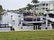 Scenic view of the canal with private boat lifts, set against tropical landscaping at 311 Garvin St # 405B, Punta Gorda, FL 33950