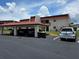 Exterior of building with covered parking and well-maintained landscaping at 311 Garvin St # 405B, Punta Gorda, FL 33950