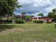 Well-maintained building exterior with lush landscaping, palms, and a manicured lawn at 311 Garvin St # 405B, Punta Gorda, FL 33950