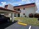 Exterior of condo with carport and landscaped front yard at 311 Garvin St # 405B, Punta Gorda, FL 33950