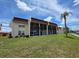 Exterior view of condo building with screened-in lanais and well-maintained lawn at 311 Garvin St # 405B, Punta Gorda, FL 33950