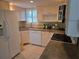Bright kitchen featuring white appliances, ample counter space, and a sink with a view at 311 Garvin St # 405B, Punta Gorda, FL 33950