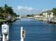 Picturesque waterfront view of a canal with docks and lush landscaping at 311 Garvin St # 405B, Punta Gorda, FL 33950