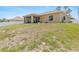 A sprawling backyard with a well-maintained lawn and a screened patio at 3138 Darius Ave, North Port, FL 34288