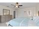 Bright bedroom with a ceiling fan, dresser, and neutral color palette at 3138 Darius Ave, North Port, FL 34288