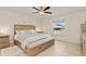 Serene bedroom with a ceiling fan, neutral decor, a large window, and a comfortable bed at 3138 Darius Ave, North Port, FL 34288
