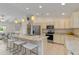 Well-lit kitchen showcasing granite countertops, stainless steel appliances, and a center island with seating at 3138 Darius Ave, North Port, FL 34288
