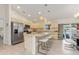 Bright kitchen featuring stainless steel appliances, granite countertops, and a breakfast bar with seating at 3138 Darius Ave, North Port, FL 34288