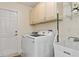 Functional laundry room with modern washer, dryer, and storage cabinets at 3138 Darius Ave, North Port, FL 34288