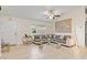 Bright living room featuring tile flooring, a large sectional sofa, and stylish decor at 3138 Darius Ave, North Port, FL 34288