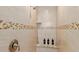 Beautiful tiled shower with a built-in bench and decorative accents at 3138 Darius Ave, North Port, FL 34288