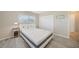 Bright bedroom features modern white bed, window, closet and light gray wood-look floors at 3171 Highlands Rd, Punta Gorda, FL 33983