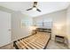 Modern bedroom features a ceiling fan, two windows, and sleek side tables at 3171 Highlands Rd, Punta Gorda, FL 33983