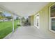 Covered patio features concrete flooring and access to the backyard via glass French doors at 3171 Highlands Rd, Punta Gorda, FL 33983