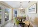 Cozy dining area with stylish lighting and access to a patio, creating an inviting atmosphere for meals at 3171 Highlands Rd, Punta Gorda, FL 33983